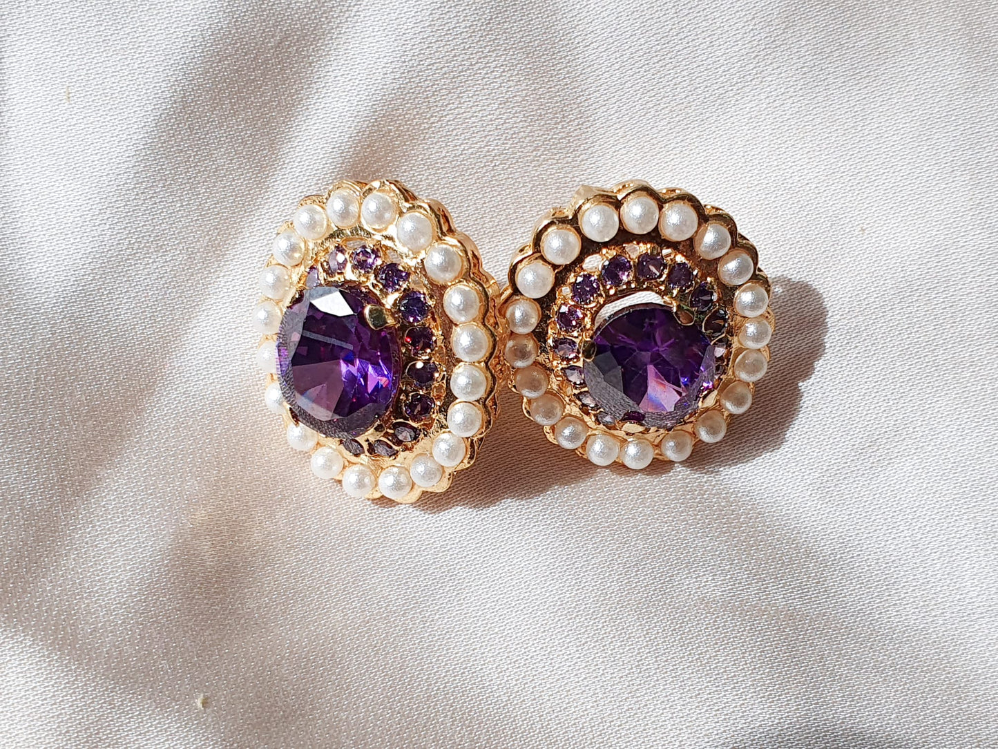 Zircon encircled by shell pearls. Earrings.