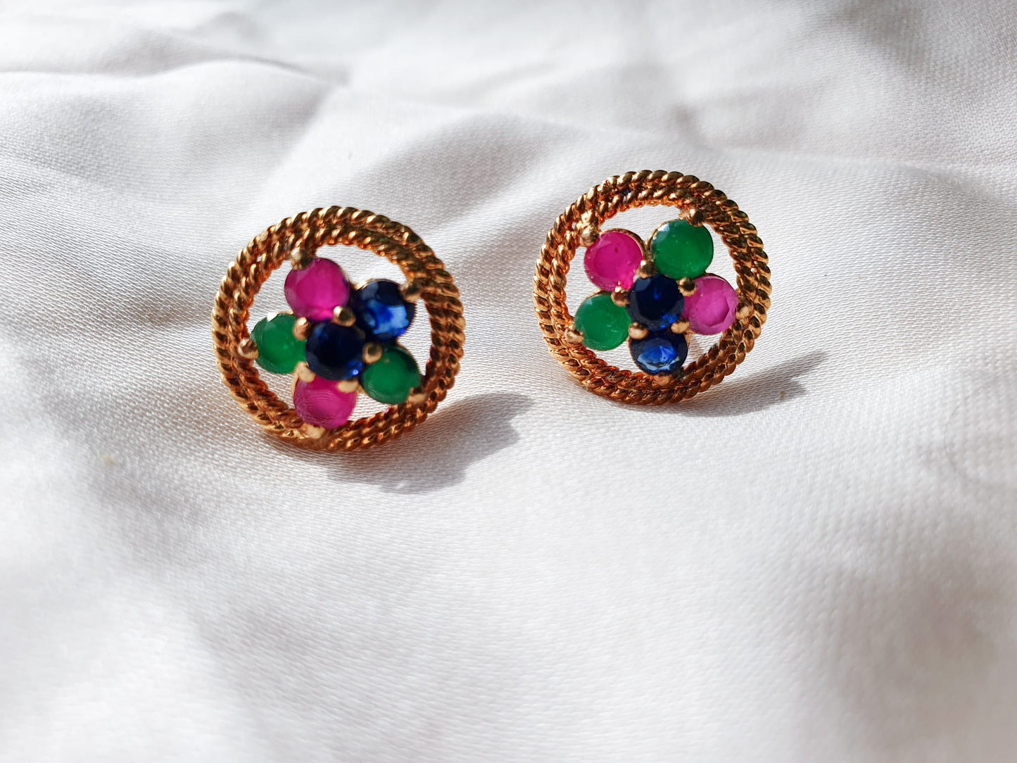 Multi color stones adorned with twisted silver wire. Earrings.