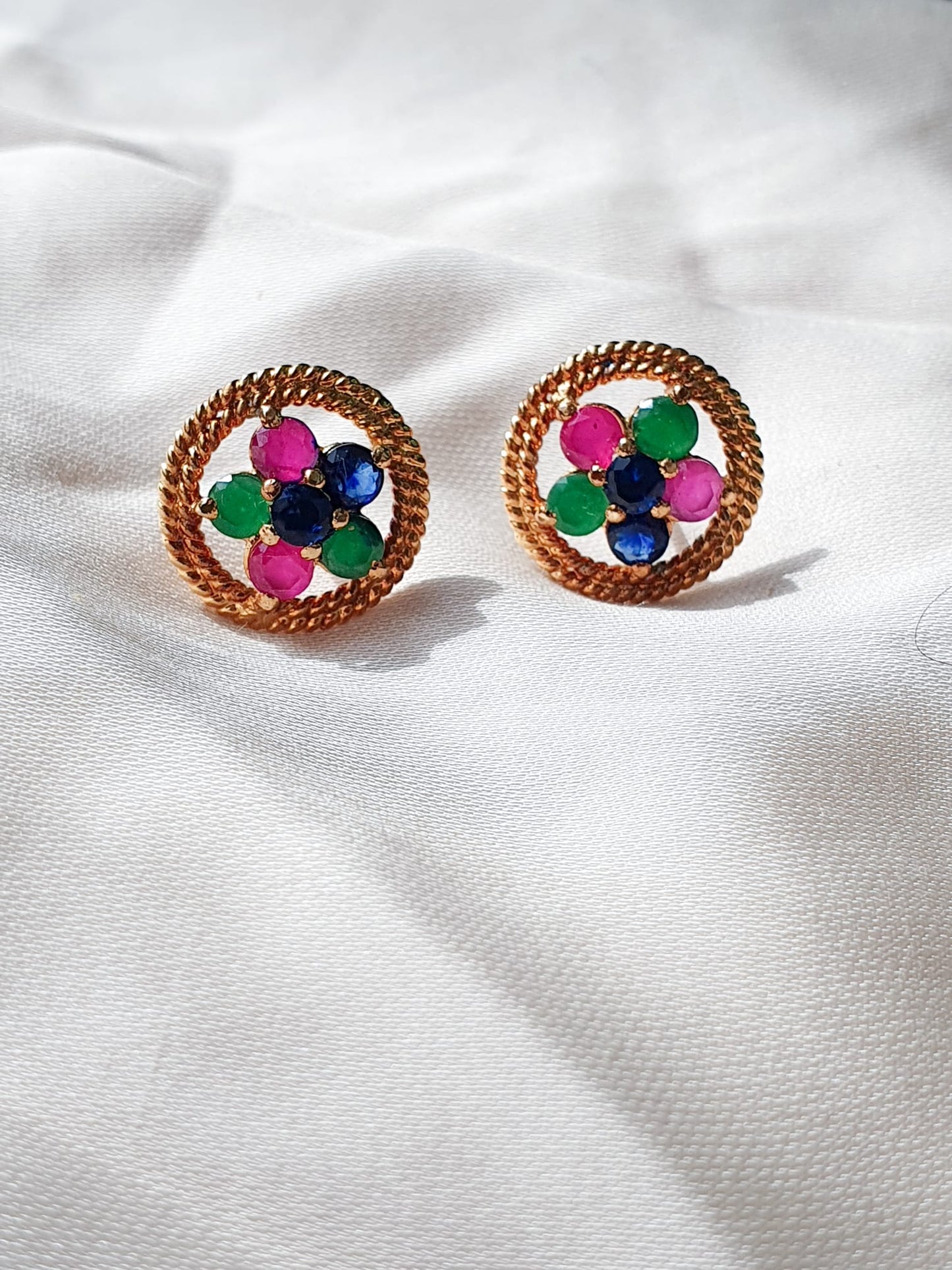 Multi color stones adorned with twisted silver wire. Earrings.