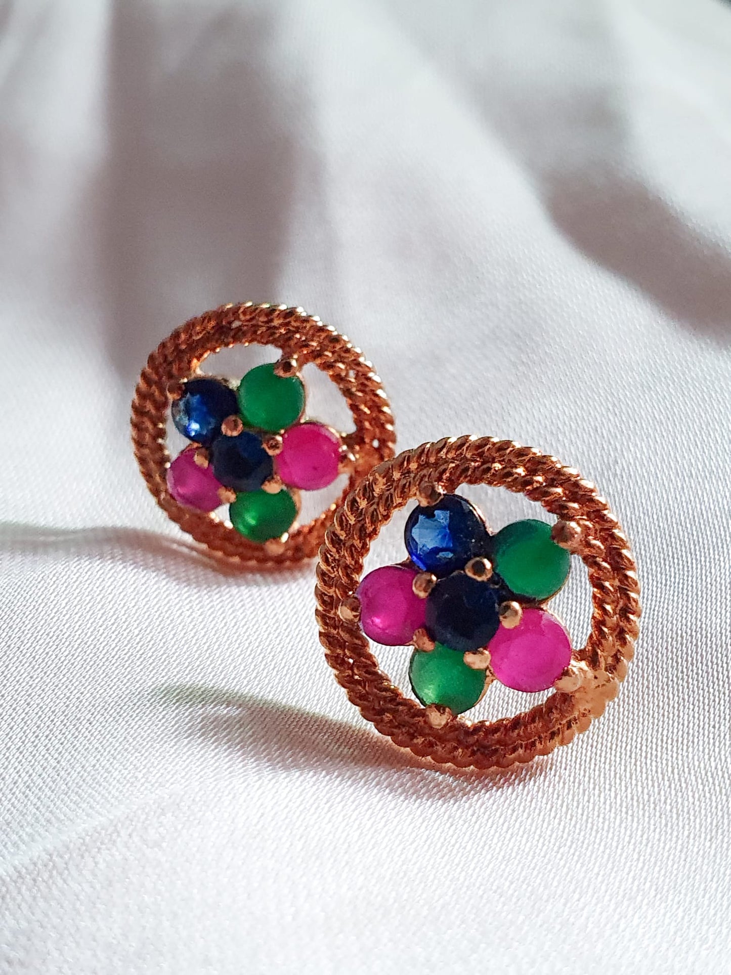Multi color stones adorned with twisted silver wire. Earrings.